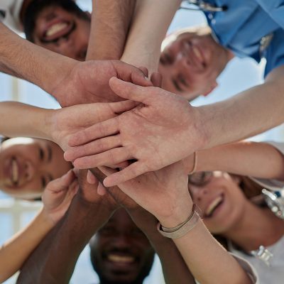 Professional Doctors Holding Each Other Hands. Multinational Medician Meeting.